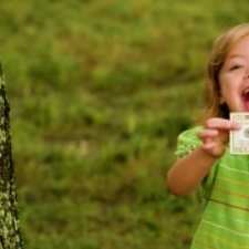 child with twenty dollar bill