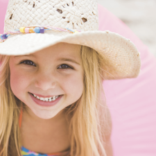 smiling girl in woven hat