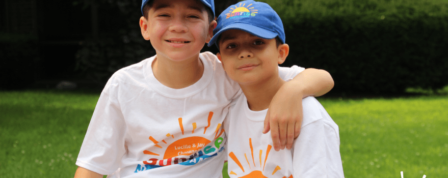 two children wearing baseball caps