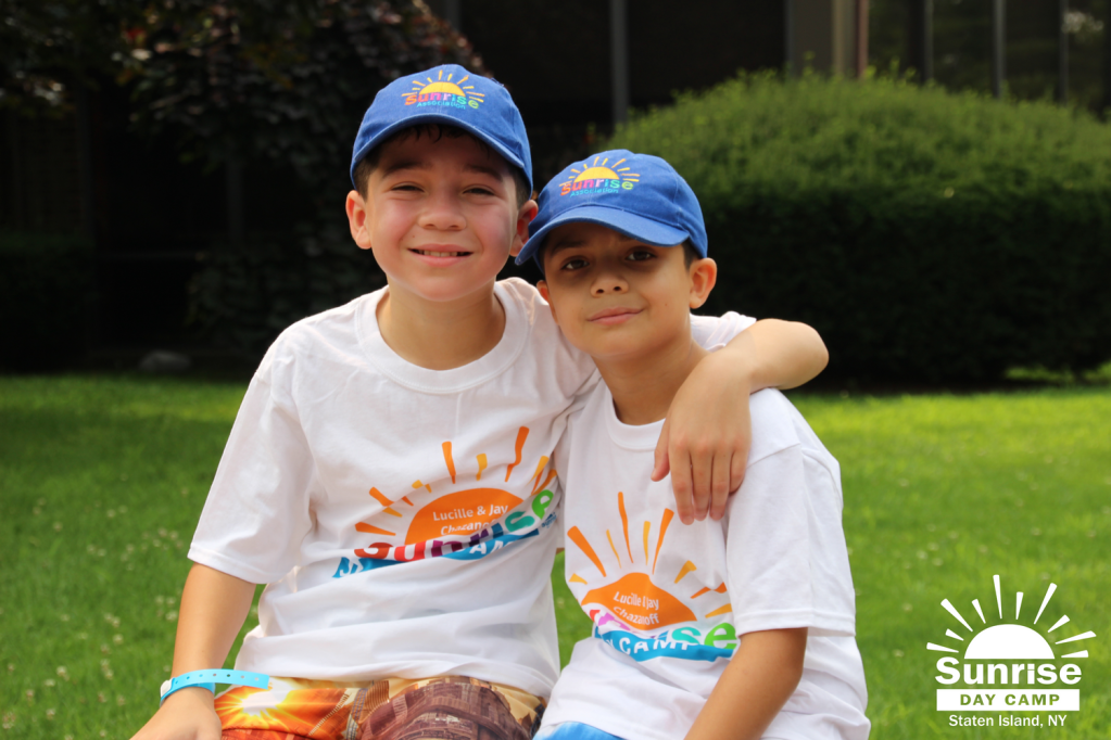 two children wearing baseball caps