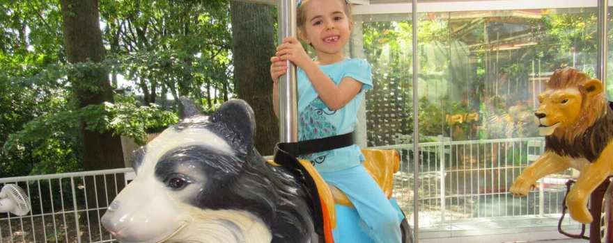 girl riding carousel