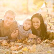 family on ground with pumpkins