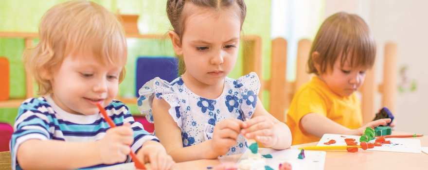 focused kids doing crafts