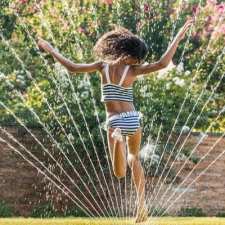 girl in sprinkler