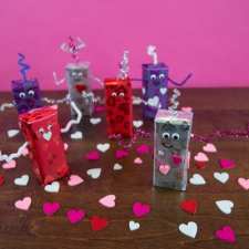 robots dancing with paper hearts