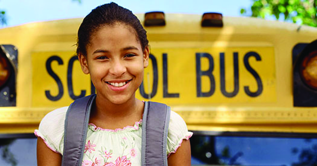 smiling girl at school bus