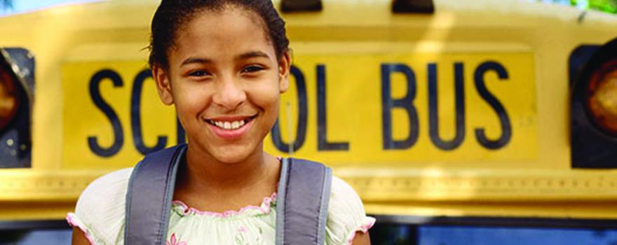 smiling girl at school bus