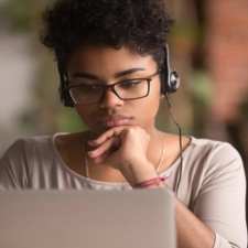 thoughtful young woman with laptop