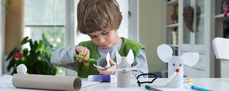 kid making paper animals