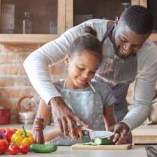 father and daughter cooking