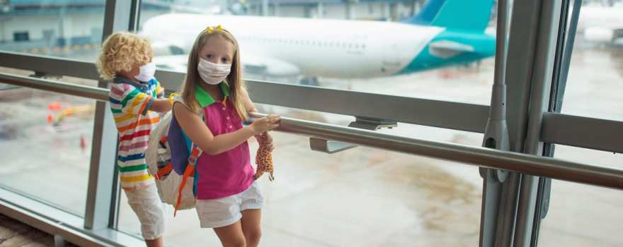 Kids in masks at airport