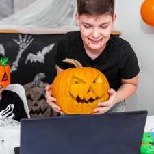 Boy showing pumpkin to virtual camera