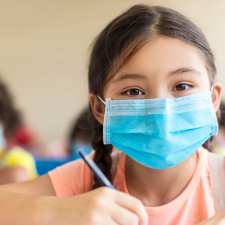 Girl in mask in school