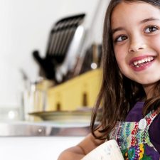 girl cooking holding bowl