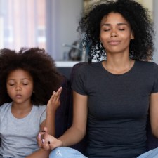 mom and daughter meditating