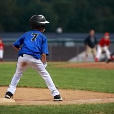 kids playing baseball on field