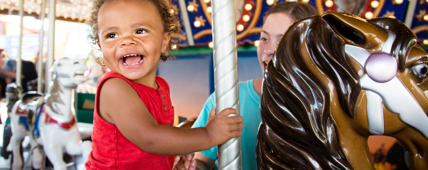 kid on carousel