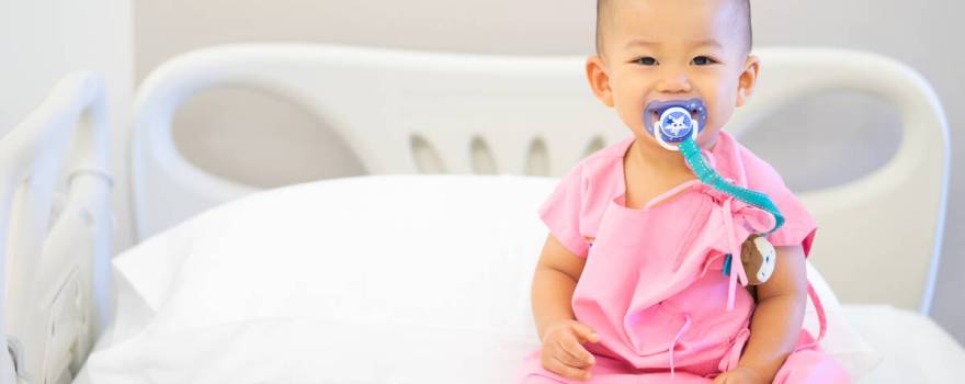 Baby in hospital bed with pacifier