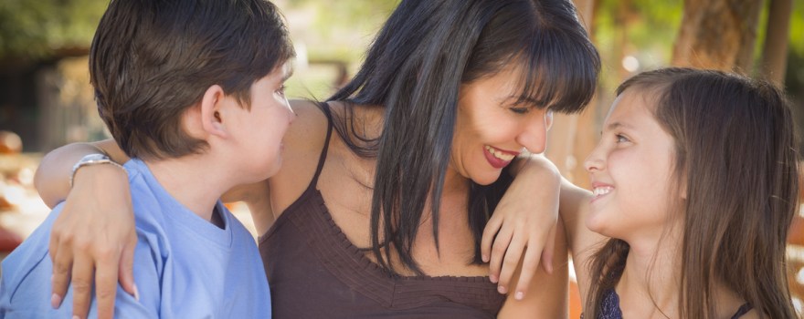 Single mom smiling with son and daughter