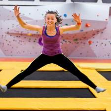 teen girl jumping at indoor trampoline park