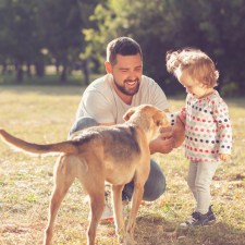 Father and child walking dog