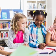 kids writing at a table