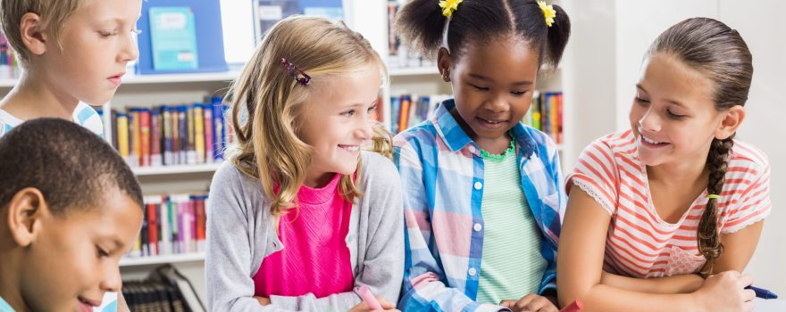 kids writing at a table