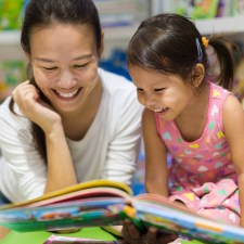 woman and little girl reading