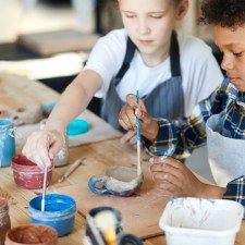 two children painting at a table