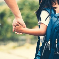 parent and young child holding hands