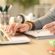 close-up of hands at a laptop