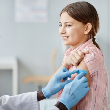 doctor putting bandage on little girl