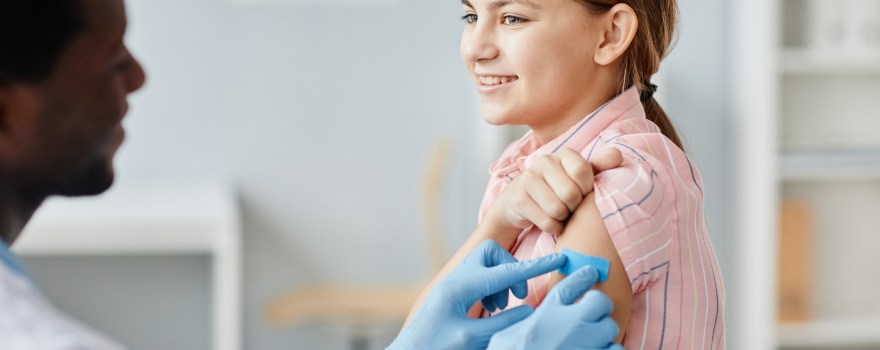 doctor putting bandage on little girl