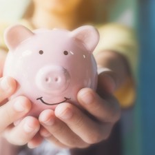 hands holding a piggy bank