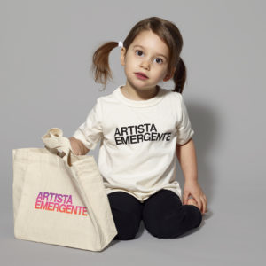 little girl wearing a T-shirt and holding a tote bag