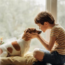 boy with dog showing benefits of pets for kids