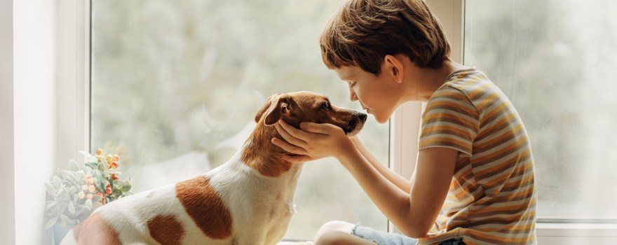 boy with dog showing benefits of pets for kids