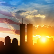 The World Trade Center in NYC with American flag in the background. This appears in an article about talking to kids about September 11.