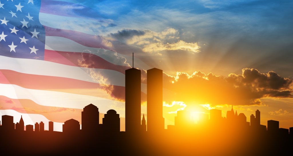 The World Trade Center in NYC with American flag in the background. This appears in an article about talking to kids about September 11.