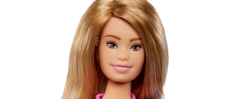 Barbie doll with Down syndrome. She's wearing a floral dress with puffy sleeves.