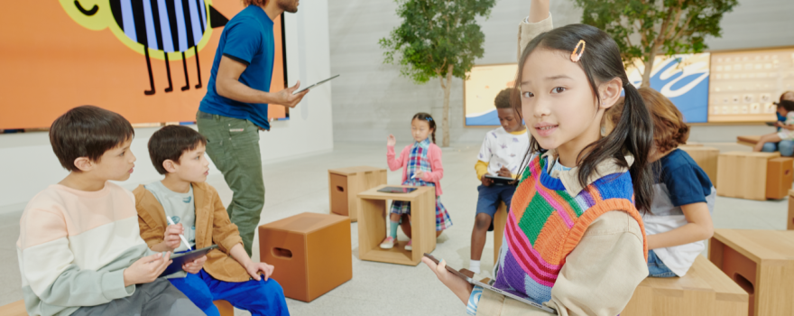 Children using iPads in a workshop during Apple Camp on Staten Island or a nearby location.