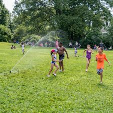 Children playing outside at Sprinklerfest at Snug Harbor