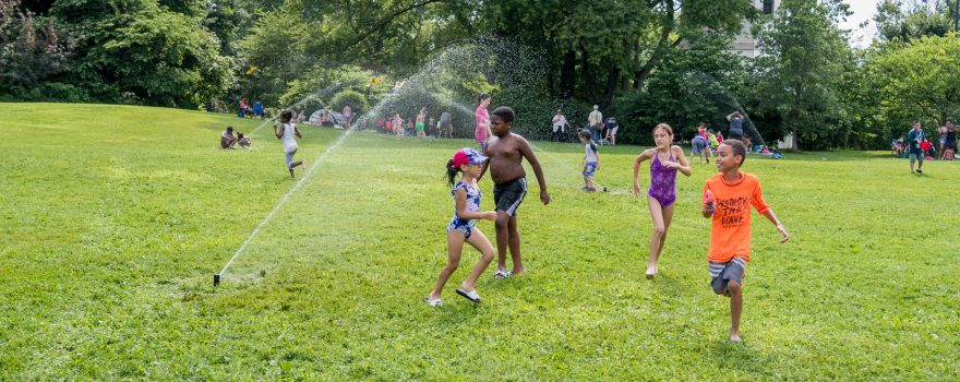 Children playing outside at Sprinklerfest at Snug Harbor