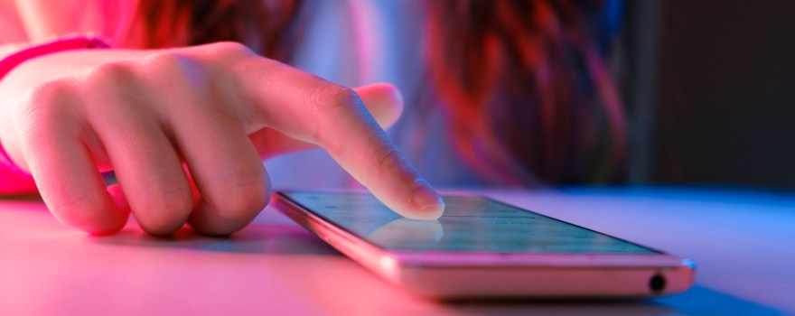 close up of a teenage girl's hand on a smartphone, a device where kids can learn about dangerous TikTok challenges