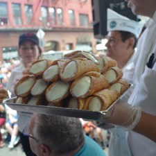 person holding a tray of cannolis at the San Gennaro Festival